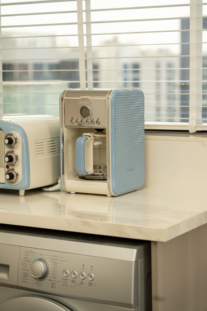 about-us-01 A stylish Dubai kitchen featuring retro pastel appliances on a marble countertop.